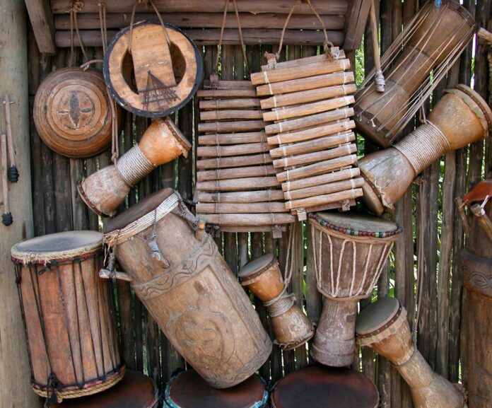 The heartbeat of Nyabinghi is the drum. Three main drums — the bass, fundeh, and repeater — drive the rhythm, each carrying its own spiritual message